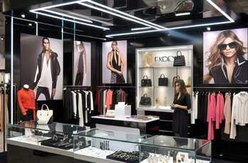 Elegant booth showcasing high-end apparel and accessories at SOURCING at MAGIC Las Vegas 2025 by Expo Creators.